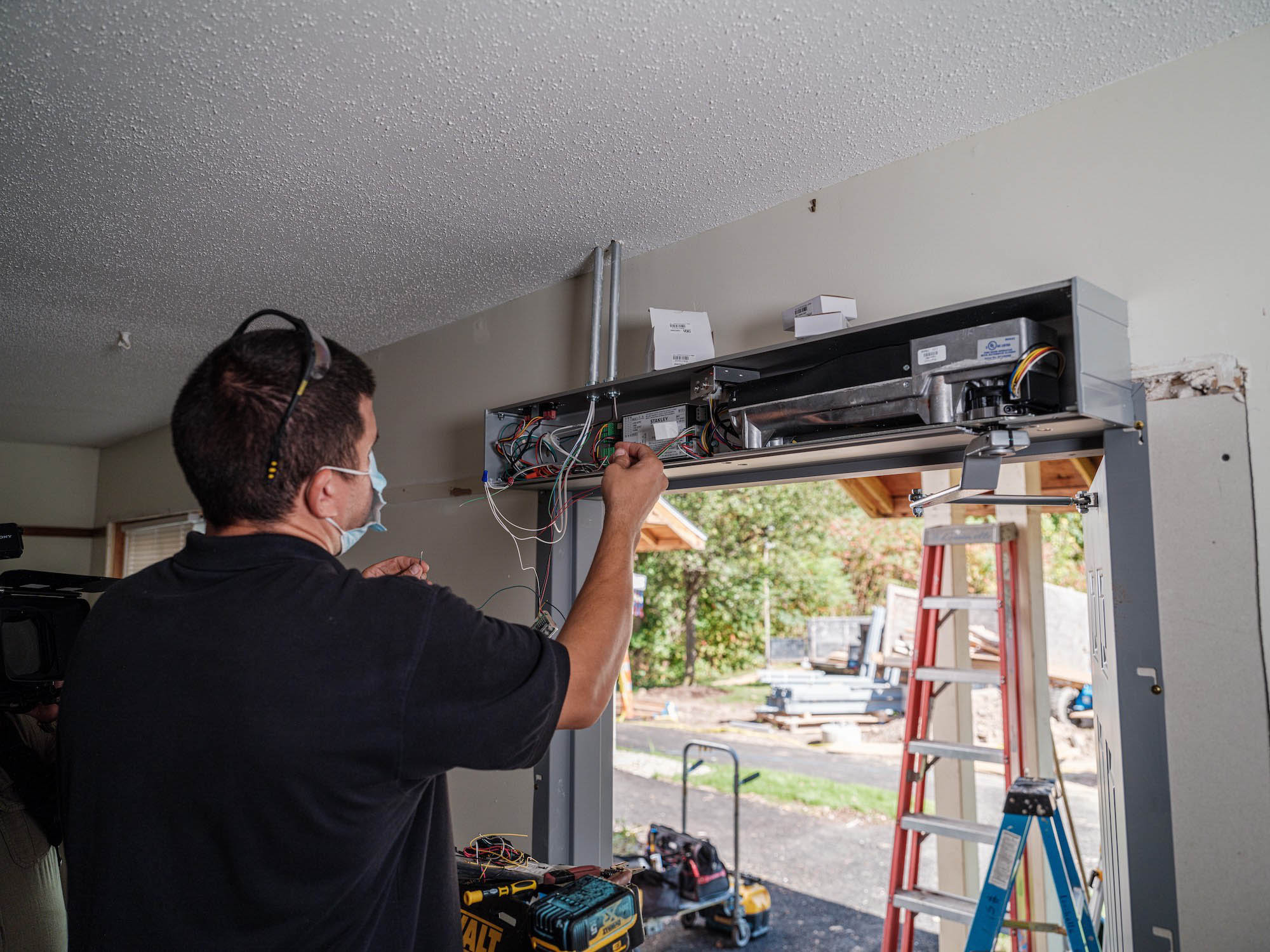 SAT New Horizons Village-4774.jpg A person installing a set of doors.