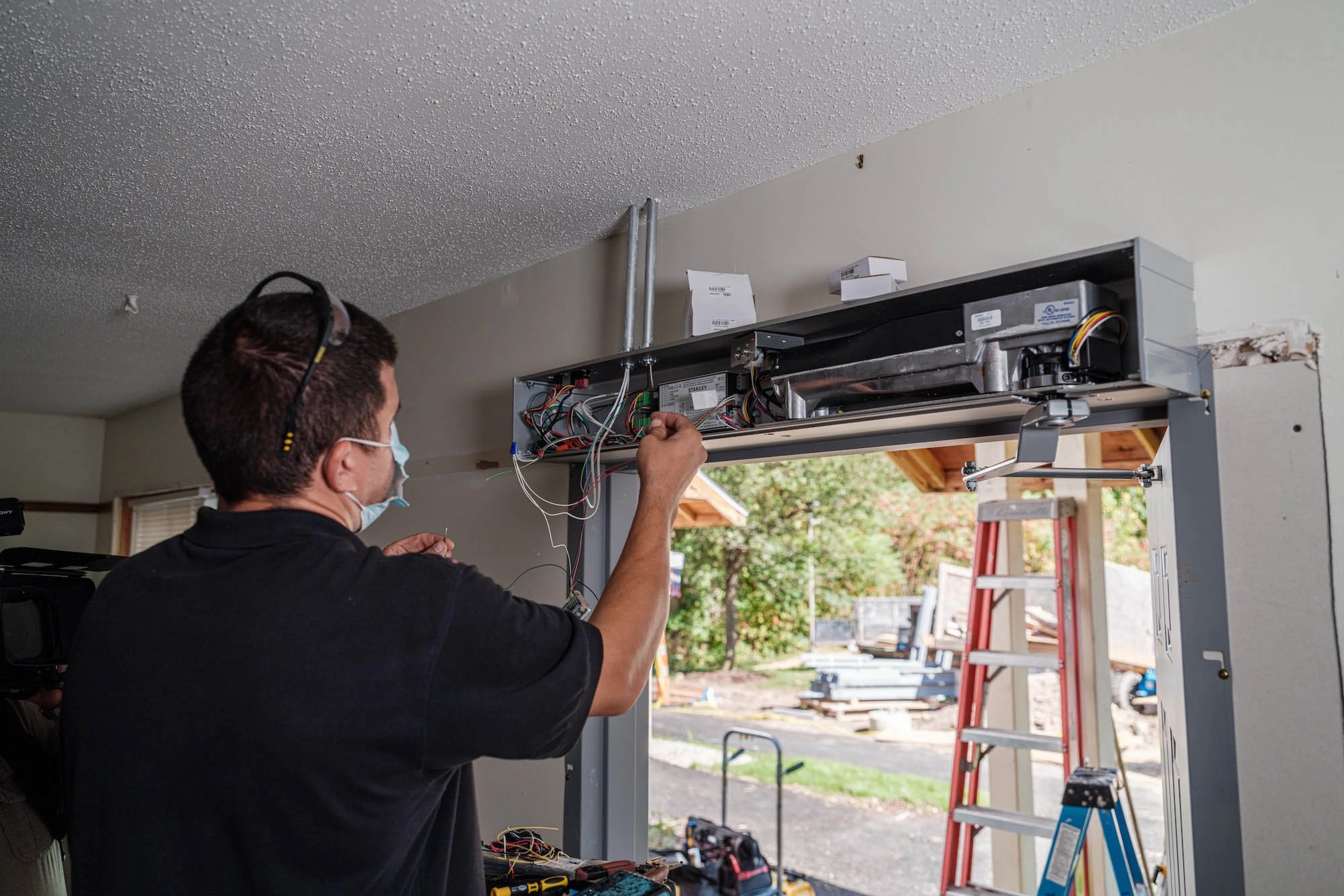 A person installing a set of doors.
