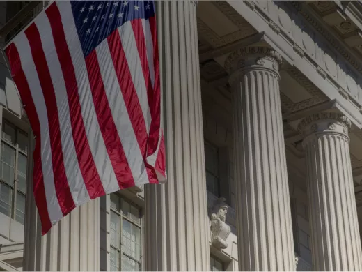 front of government building with American flag