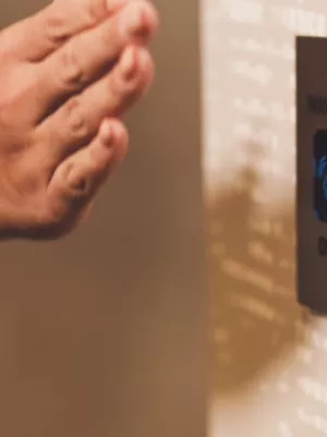 Hand waves in front of sensor to open door.