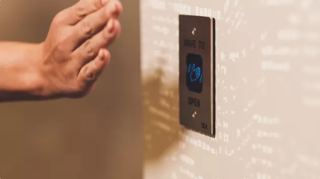 Hand waves in front of sensor to open door.