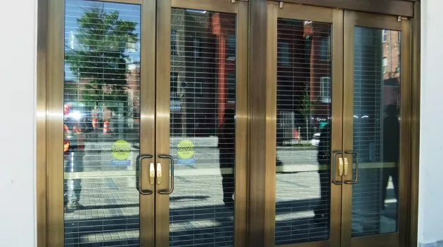 Manual balanced doors at building entrance.