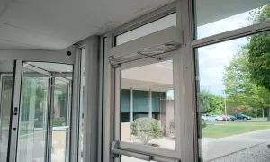 A door opener attached to the top of the door.