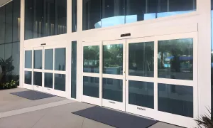 A forced entry resistant automatic sliding door on a retail store front