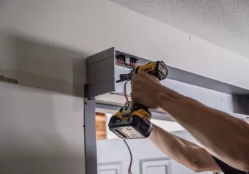 A person installing a set of doors.