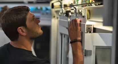 automatic door technician looking in door header