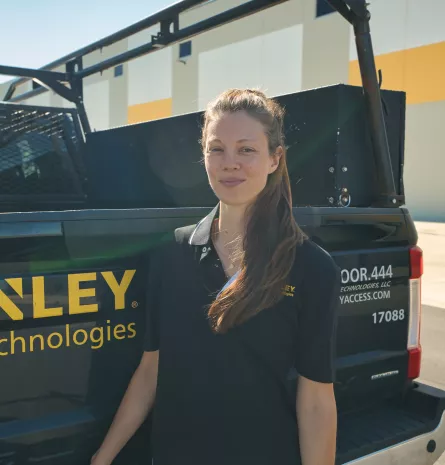 woman standing in front of company vehicle