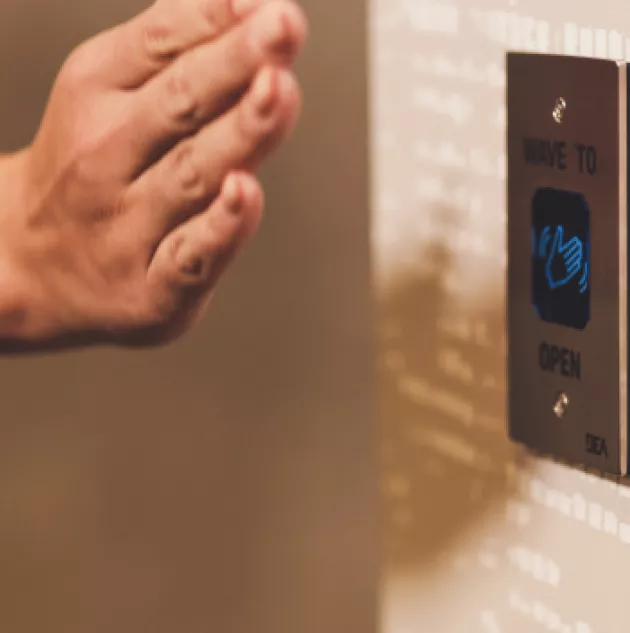 wave-to-open.jpg Hand waves in front of sensor to open door.