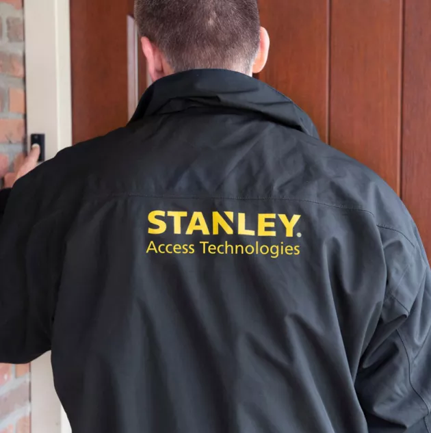 A person wearing a Stanley access technologies jacket.