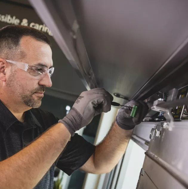 SAT x Fishers, IN - Sept 2021-14.jpg A person performing maintenance on a door.