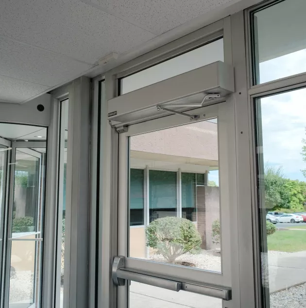 A door opener attached to the top of the door.