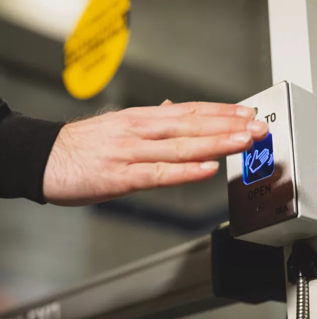 A hand pressing a button.