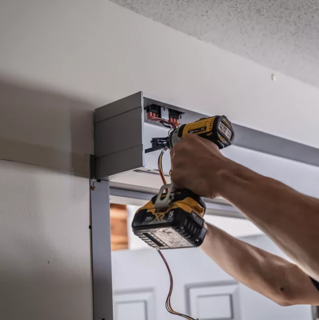 A person installing a set of doors.