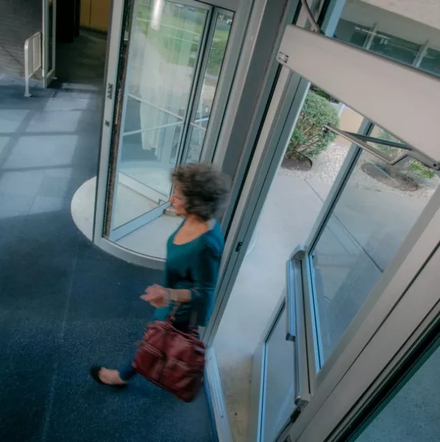 A woman walking through a door.