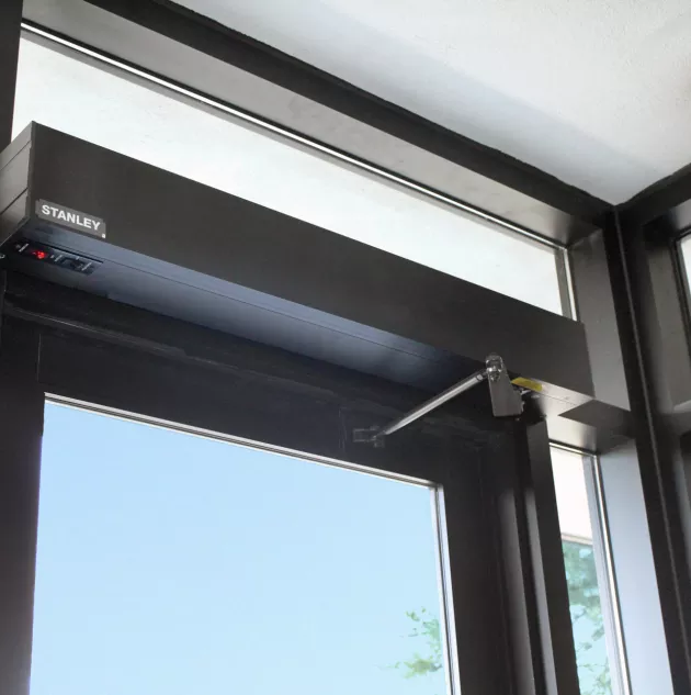 A swinging door opener mounted on a door.