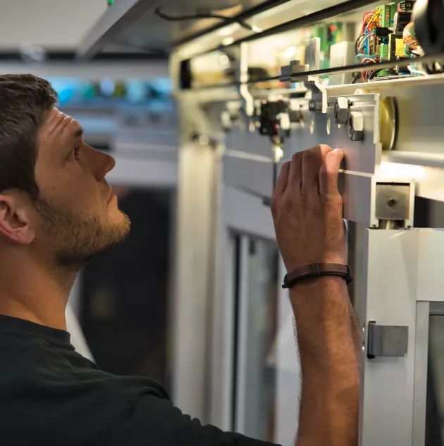automatic door technician looking in door header