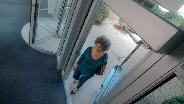 A person walking through a set of doors.