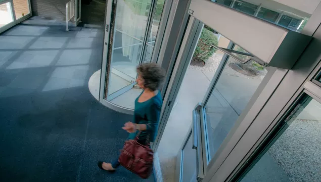 A person walking through a set of doors.