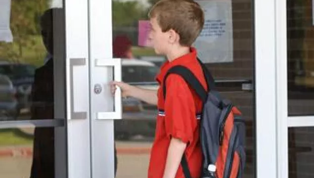 A child opening a door.