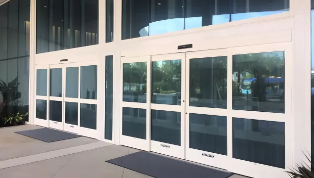 A forced entry resistant automatic sliding door on a retail store front